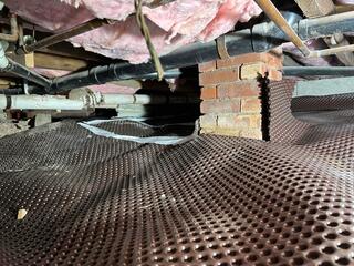 Drainage Matting Placed Over the Dirt Floor