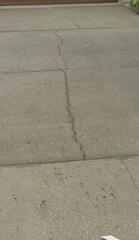 The homeowner noticed large cracks in their concrete driveway, along with areas where the slabs had become uneven after work trucks had recently caused damage on their property.