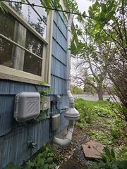 Radon system tucked in cove on front of home