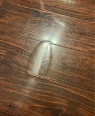 Close-Up of Water-Damaged Hardwood Flooring in Frisco, TX - Buckling and Surface Deformation