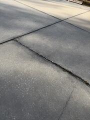 Settlement of the underlying soil caused the homeowner's concrete driveway slabs to sink, creating troublesome tripping hazards.
