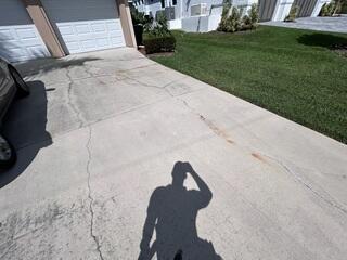 The homeowner's driveway had sustained significant damage from settlement, resulting in widespread cracking and uneven slabs.