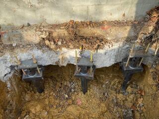 Helical Piers Lined Up Along Footer