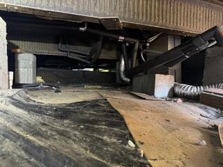 Dirty Crawl Space With Cardboard Laid Down