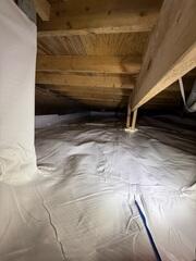 After installation, the crawl space is fully encapsulated, bright, and dry, providing long term protection for the home and improved air quality above.