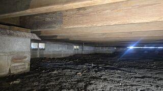 During the inspection of the home's crawl space by the LRE Design Specialist, it was discovered that the wooden floor joists had lacked proper support from below, causing them to slope.