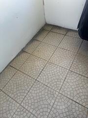The homeowner's concrete back patio had gradually settled over the years, causing the slabs to sink enough for water to begin intruding inside the home.