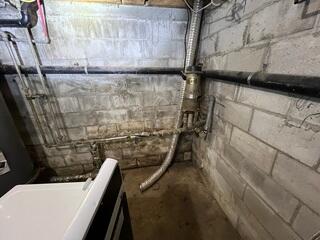 A damp basement with drainage problems and water-damaged walls
