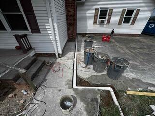 Exterior Drainage Line Installation to Redirect Water Away from the Foundation