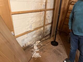 Visible Water Damage and Efflorescence on Basement Foundation Wall