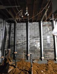 Connecting the braces to a supplemental beam attached to the floor joists