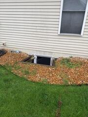 These window wells were old pieces of wood. The wood was shifting and the homeowner was concerned. They also weren't covered which allowed for a lot of water to pool by the basement windows.