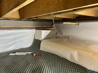 Cracks are sealed spray foam insulation between the concrete block walls.