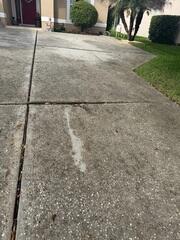 Soil settlement beneath the driveway had caused the slabs to shift and sink, creating numerous tripping hazards.