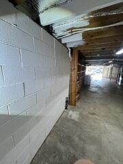 This photo clearly shows the basement wall beginning to bow inward under the constant pressure of the surrounding soil. Left unaddressed, bowing foundation walls can continue to worsen over time, making permanent stabilization with the Geo-Lock&reg; Wall Anchor System an important step in protecting the home's structural integrity, especially before it went on the market.