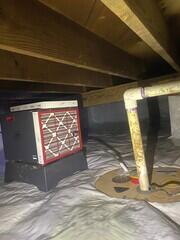 The dehumidifier is set to keep humidity low and to drain to the sump pump