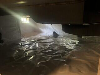 Cross laminated vapor barrier sealed over crawl space floor and wall