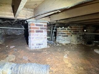 Evidence of moisture on the brick piers of this home.