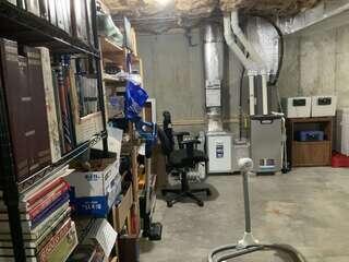 One-point radon piping installed in the unfinished basement.
