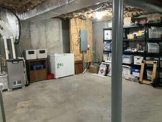 One-point radon piping installed in the unfinished basement.