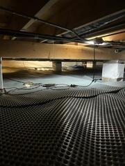 Drainage matting forms a permanent seal for leaking crawl space floors.