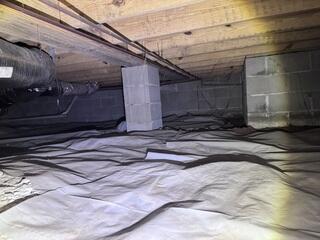 The signs of water and moisture in the crawl space are evident on the block wall of the crawl space.
