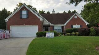 Old, shingled home storm damaged roof