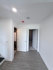 This area is on the landing of the basement here is a place for storage and electrical