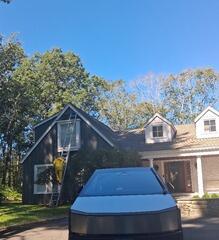 Professional crew in action power washing upper-story siding to ensure a clean surface for painting.