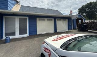 Meticulous surface protection and masking ensure flawless garage and door finishes.