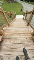 Worn, faded deck treads before professional cleaning and protective wood treatment.
