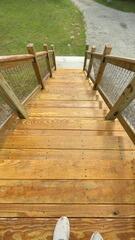 Refinished deck staircase featuring a fresh, protective semi-transparent sealer for maximum durability.