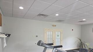 Before: Dull off-white walls make the treadmill area feel dim and dated.