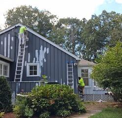 Work in progress: Precision spot-priming and siding prep underway to ensure complete surface protection and flawless paint adhesion