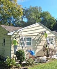 Detailed inspection and surface preparation along the side exterior to fix peeling paint and damaged trim.