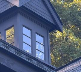 Precision exterior painting detail on a custom rooftop cupola and weather vane.