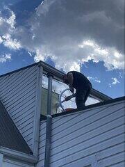 Crewman injection foam into exterior walls of home