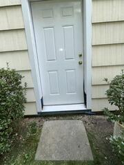 Cleanly repaired and recaulked exterior door frame, completely prepped for fresh topcoats.