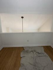 Open interior wall cutout above lower room before wood paneling installation.