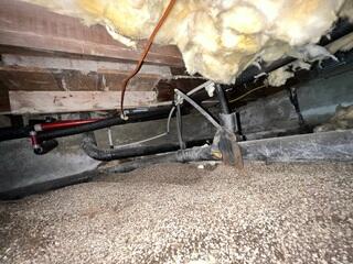 Exposed Crawl Space Before Moisture Control