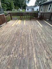 Fully repaired deck surface reinforced with structural board replacements, ready for staining
