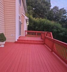 Freshly stained multi-level wood deck featuring a smooth, rich finish that guarantees long-lasting weather protection.