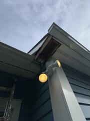 Identifying rotted eave section and exposed soffit structure prior to repair.