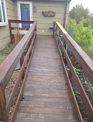 Deep power washing and sealant application to restore weather-beaten ramp surfaces and railing structures.