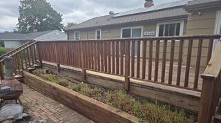 Complete multi-level deck restoration featuring custom built-in planter boxes and fresh protective staining.
