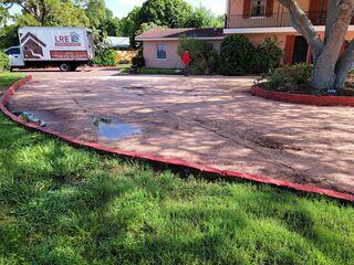 The homeowner's concrete driveway had settled and become uneven over time due to underlying soil erosion, resulting in water pooling in several areas.