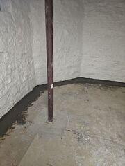 Along the walls of this basement we installed our sub-floor drainage system, which leads leaks towards the sump pump rather than letting them gather at the seam of the floor and the wall.