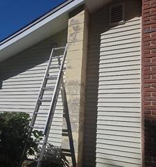 Before: Preparing the ladder for high-reach surface prep, scraping, and priming on a worn exterior chimney