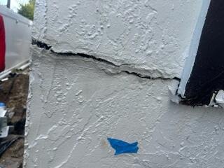 The homeowner had noticed settlement issues affecting both the foundation of the home's main structure and the rear addition, with large cracks appearing in the exterior walls.