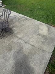 Due to the settlement of the underlying soil, the concrete patio slabs had shifted and cracked, creating troublesome tripping hazards.